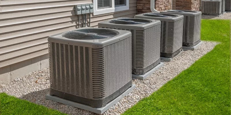 Three air conditioning units positioned in front of a home, representing Central AC Services for reliable cooling options